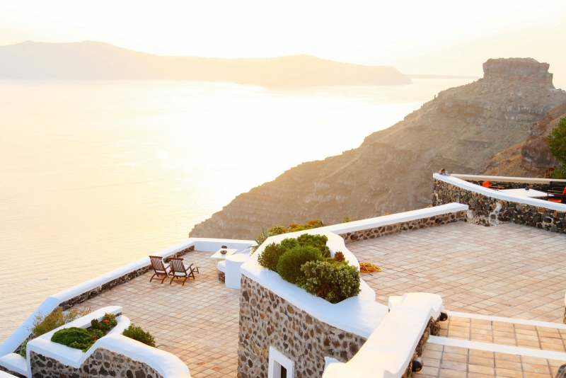 Balcone vista mare con due sdraio illuminate da una calda luce dorata al tramonto Bike Tour Evolution