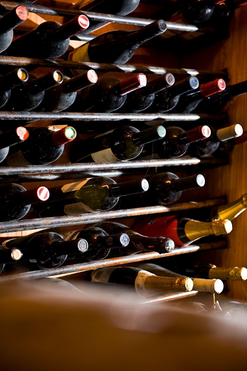 Bottiglie di vino disposte in orizzontale in un portabottiglie, pronte per linvecchiamento o la degustazione Bike Tour Evolution